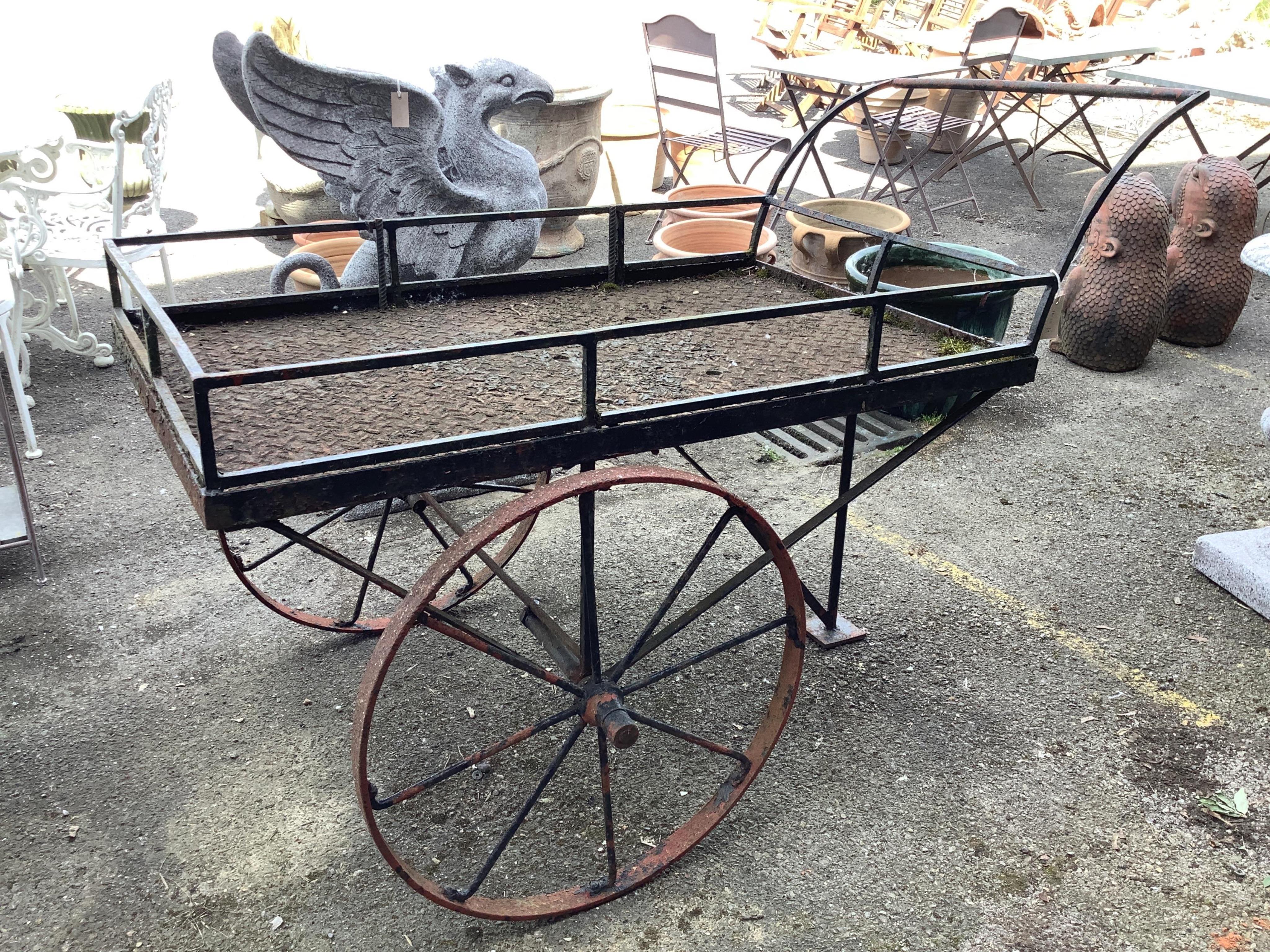A wrought iron garden barrow, width 76cm, length 152cm, height 106cm